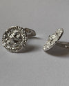A pair of silver-toned cufflinks with textured, hammered circular faces, shown on a neutral gray background.