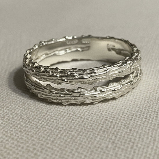 double silver textured rings on a light gray background