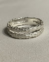 double silver textured rings on a light gray background