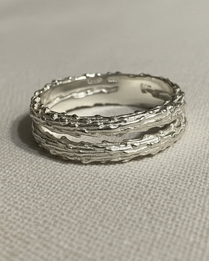 double silver textured rings on a light gray background