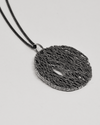 Black textured pendant necklace on a light gray background