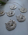 Five textured silver pendats,half moon shaped, with a textured surface and handset stones in different colors