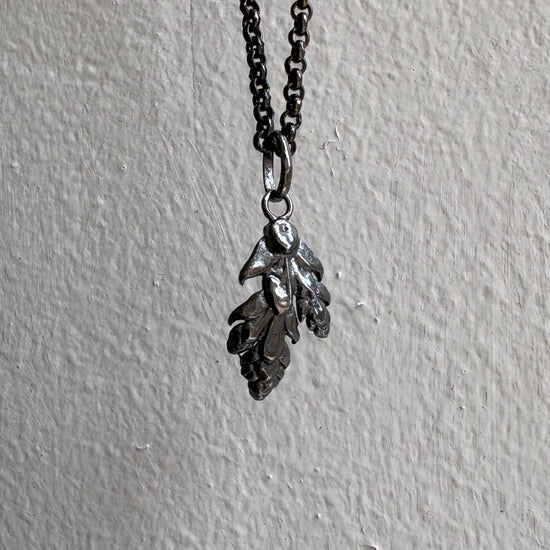Necklace with leaf-shaped pendants on a gray background