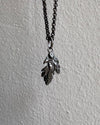 Necklace with leaf-shaped pendants on a gray background