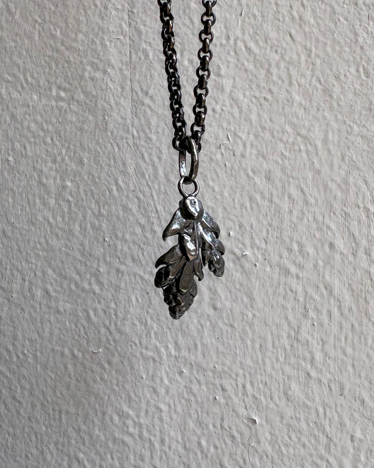 Necklace with leaf-shaped pendants on a gray background