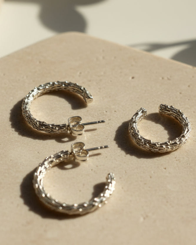 Pair of silver hoop earrings on a light background