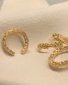 Gold hoop earcuff textured on a beige background